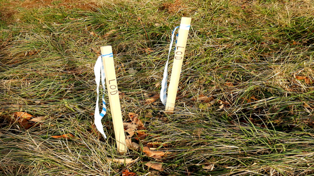 white flag markers land surveying